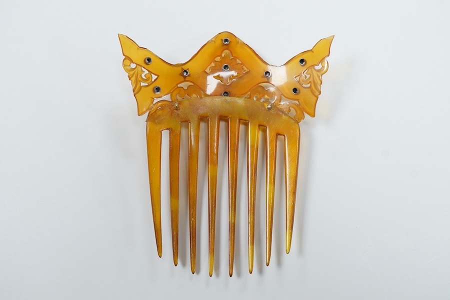 An early 20th century tortoiseshell hair comb set with eleven diamonds, 99mm by 83mm.